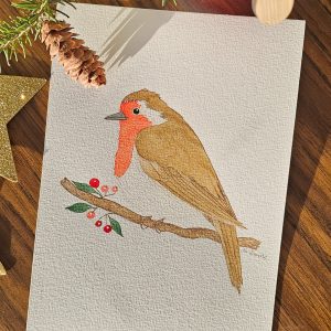 Aquarelle d’un rouge-gorge, délicat et coloré, évoquant la douceur de l'hiver.